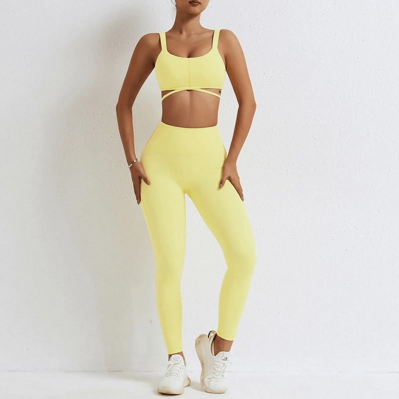 Woman wearing a bright yellow seamless gym sports suit with bra and leggings, perfect for yoga or fitness, made from nylon and spandex.